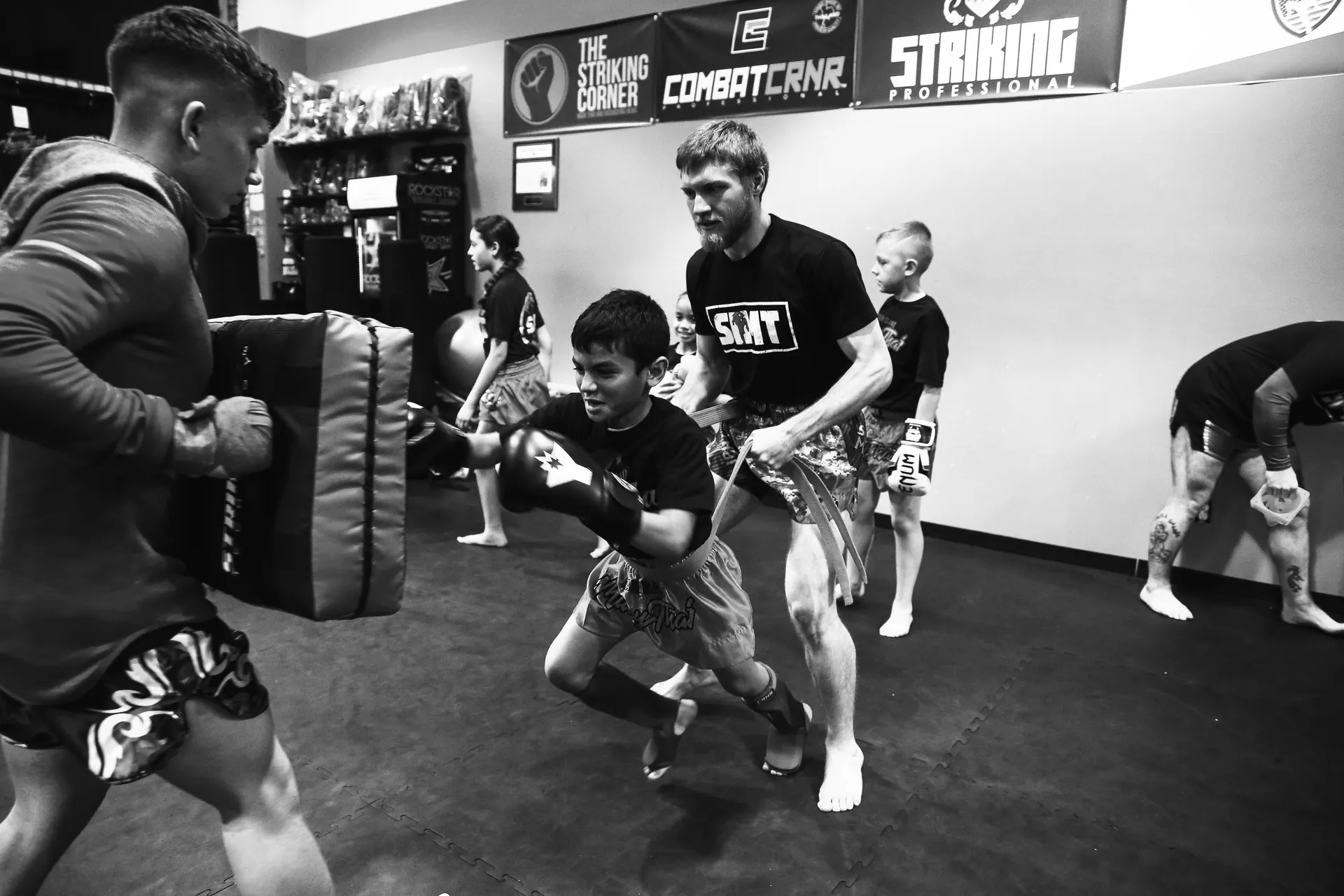 Adult Muay Thai class training with heavy bags at Legion gym