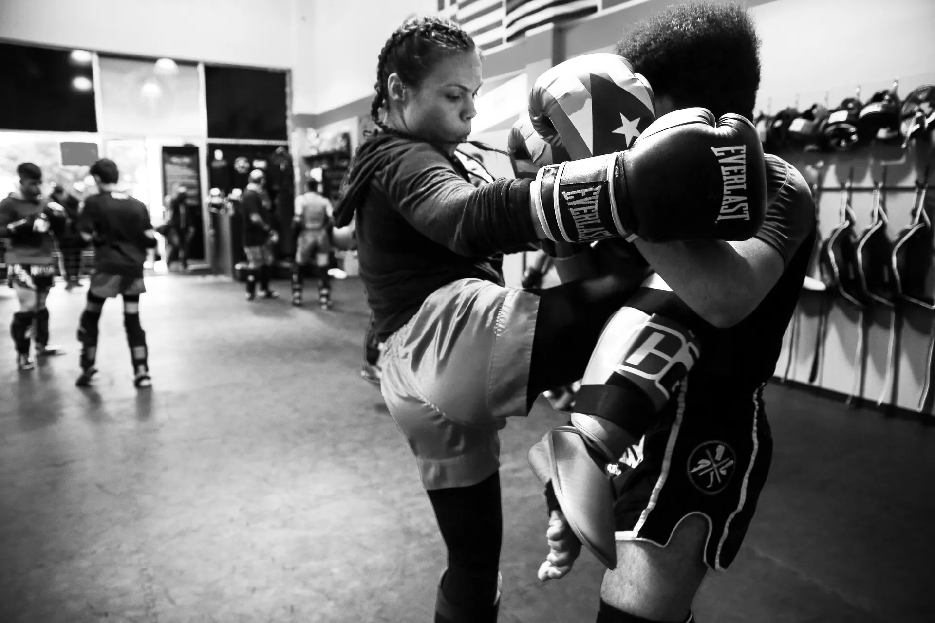 Teen students practicing kicks on training pads